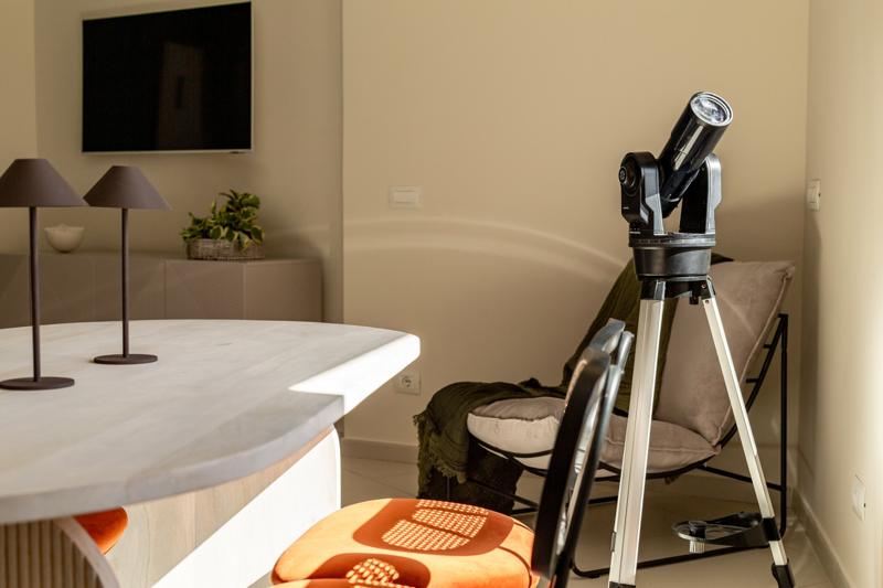 A telescope on a tripod in the living room