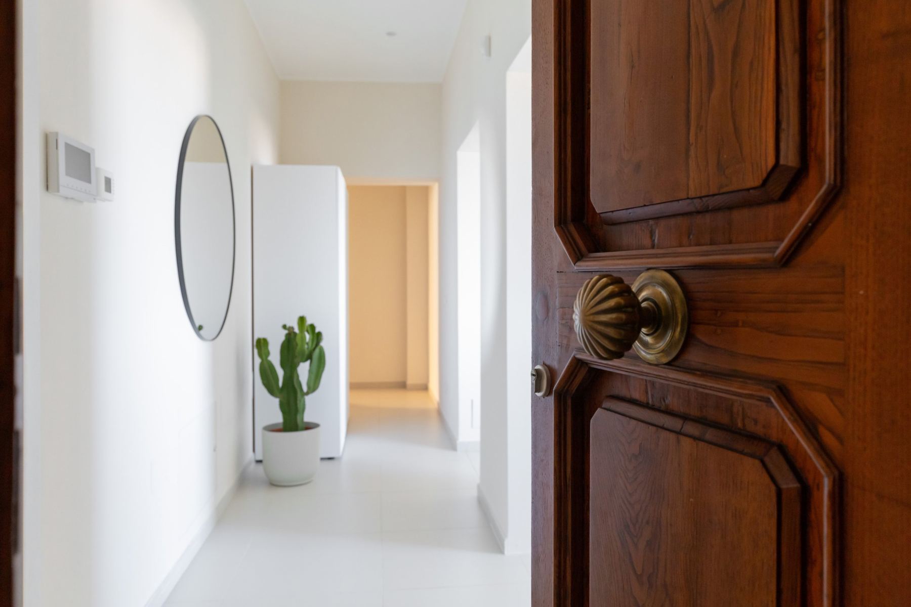The old wooden front door of Tàparas opening onto a bright hallway
